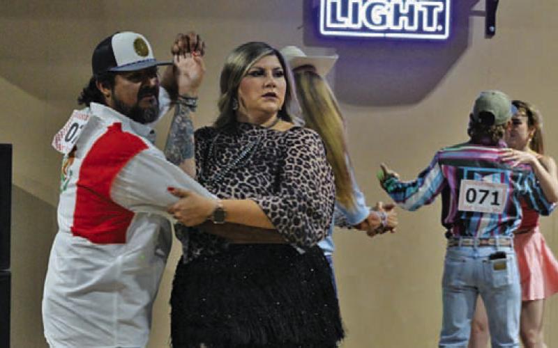 Armondo Rosales helps his dance partner, Karli Rosales, make their way around the dance floor. ERICK MITCHELL | DISPATCH RECORD