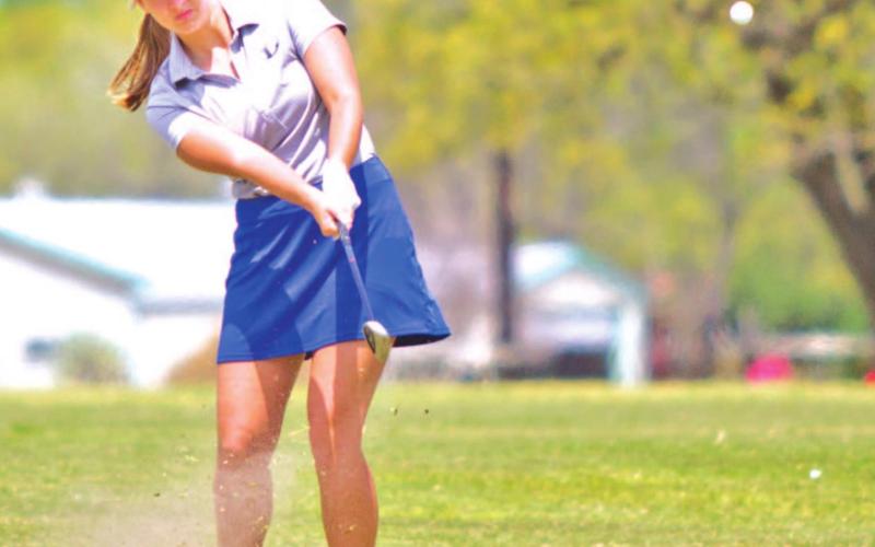 Shaylee Wolfe follows through on a pitch shot during her junior season. FILE PHOTO