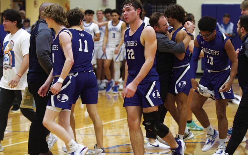 The Badgers congratulate one another after their third consecutive district win. HUNTER KING | DISPATCH RECORD