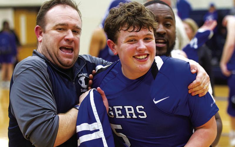 Aaron Nuckles, left, and his son, freshman Aidan Nuckles, celebrate the win over Jarrell. HUNTER KING | DISPATCH RECORD