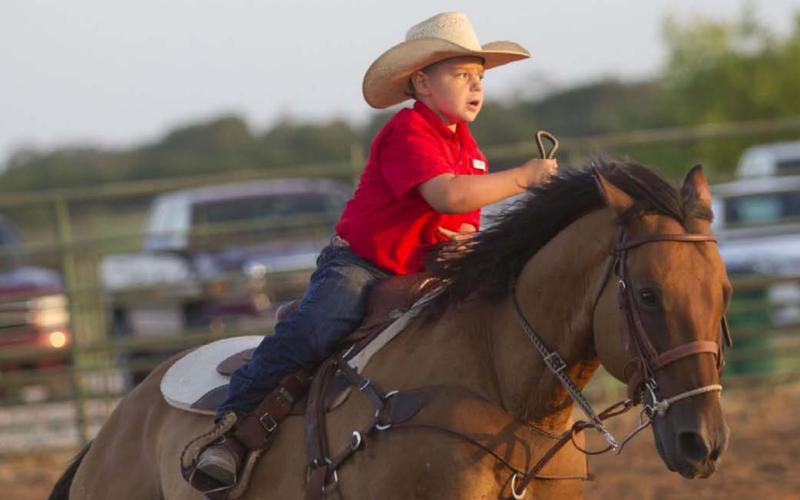 A rider at the Lometa FFA Junior Rodeo takes a lap around the Bar 3 Arena on Friday night as the rodeo gets underway. HUNTER KING | DISPATCH RECORD