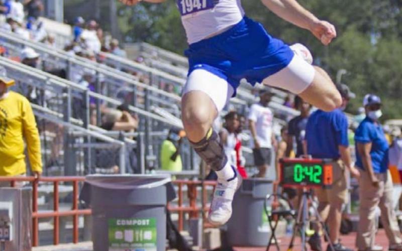 Badger senior Cade White competes in long jump at state on Thursday in Austin. JEFF LOWE | DISPATCH RECORD