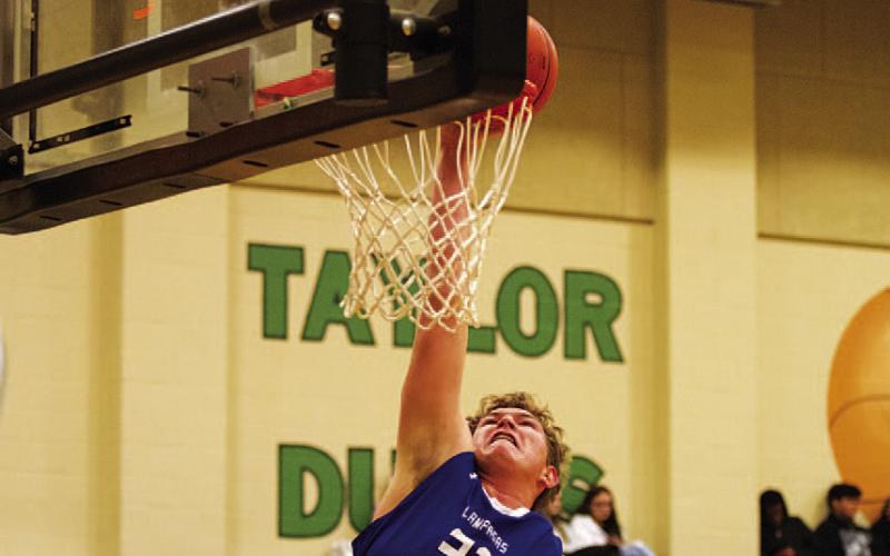 HUNTER KING | DISPATCH RECORD Beau Patterson reaches for a dunk -- one of two for the Badgers in the game.