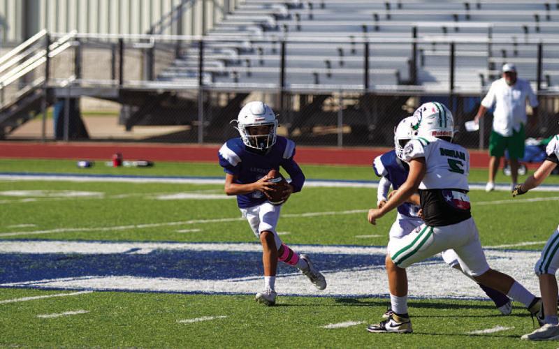 Kaylor Chapa rolls to his right during a BBYL game. HUNTER KING | DISPATCH RECORD