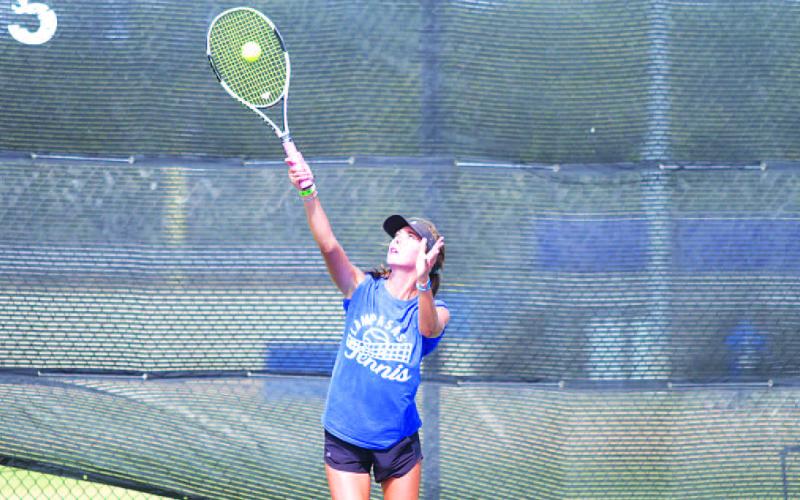 Chesley Breuer makes contact on a serve during a match last week. HUNTER KING | DISPATCH RECORD