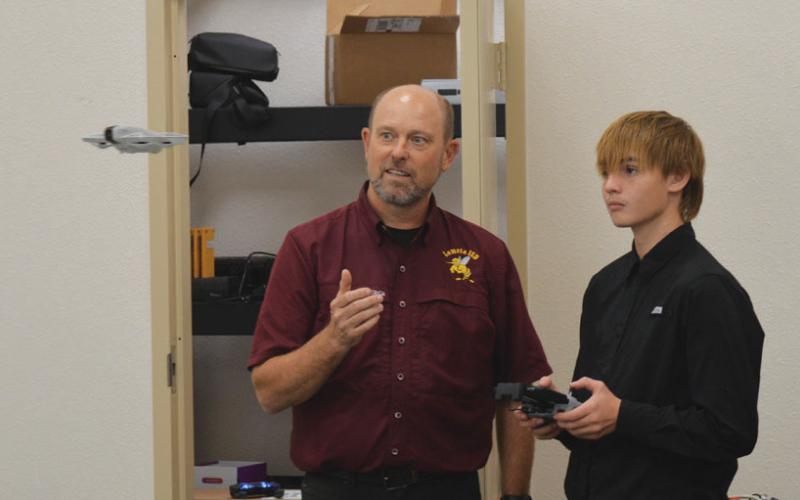 Lometa ISD Superintendent Rob Moore gives Everett Sharrock a short drone tutorial during Tuesday’s open house. Erick Mitchell | Dispatch Record