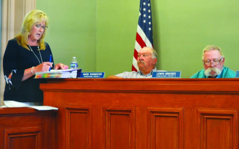 ERICK MITCHELL | DISPATCH RECORD County Auditor Tragina Tallant presents expense and revenue numbers to the Lampasas County Commissioners Court before adoption of the 2024-2025 budget and tax rate. Also pictured are Precinct 4 Commisioner Mark Ranwater, in center, and Precinct 3 Commissioner Lewis Bridges.