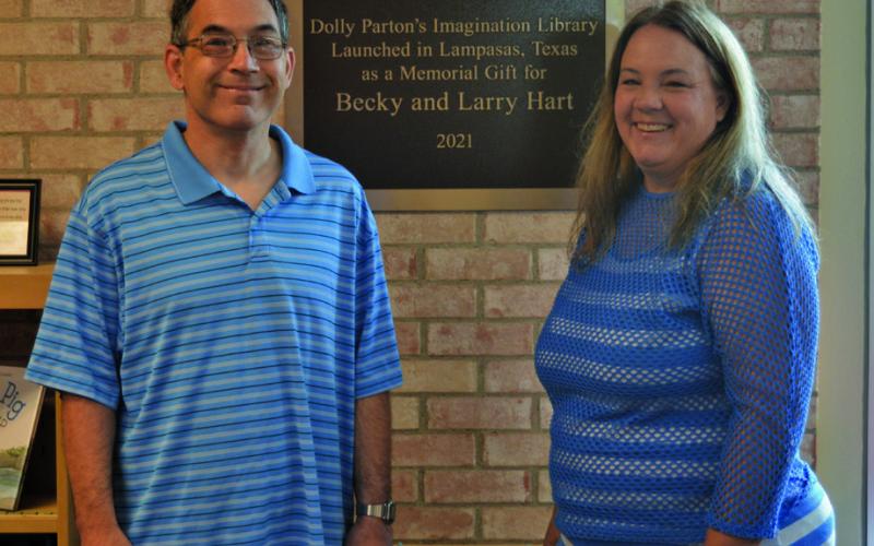 Tyler Byrd and his sister Elizabeth Byrd pose for a photo with the plaque honoring their late parents, Becky and Larry Hart. A donation from Elizabeth in honor of her parents helped launch the Dolly Parton’s Imagination Library program in Lampasas in 2021. ERICK MITCHELL | DISPATCH RECORD