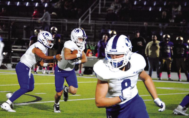 HUNTER KING | DISPATCH RECORD Jett Walker takes the handoff from David Flores during last week’s game against Marble Falls.