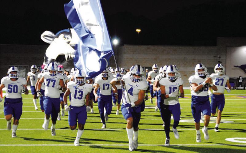 HUNTER KING | DISPATCH RECORD Aden Rascoe leads the Badgers onto the field with the Lampasas flag before every game.