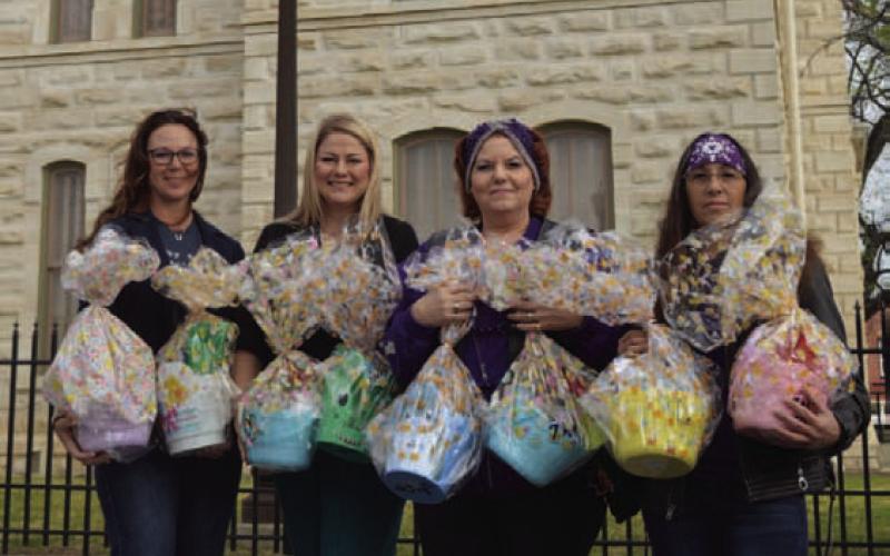 Shown left to right: Lampasas CPS Board President Colleen Eckermann and Board Treasurer Crystal Banks receive Easter egg baskets from Silverbacks Motorcycle Club members Diane Trujillo and Angelicca Conner. The baskets will go to children in CPS care. ERICK MITCHELL | DISPATCH RECORD