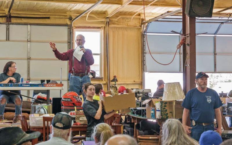 Auctioneer Rex Hooten announces items to a large crowd during the annual fundraiser for the Kempner Volunteer Fire Department. Adam barrios | DISPATCH RECORD