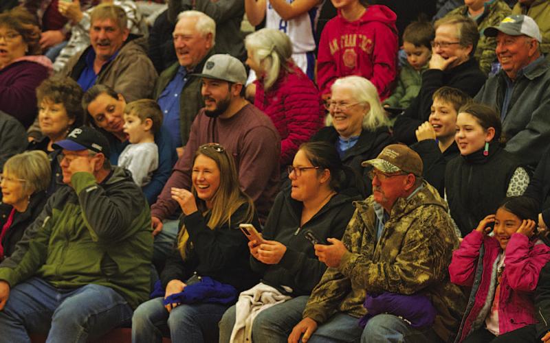 Members of the community look on in laughter as donkeys move up and down the basketball court at Saturday’s event in Lometa. HUNTER KING | DISPATCH RECORD