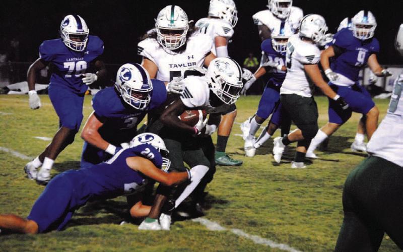 Levi Rivera (20) and Reed Jerome (3) are in on a tackle for loss during last Friday’s game. HUNTER KING | DISPATCH RECORD