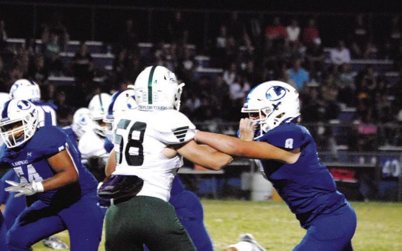 Preston Isom blocks the edge for the Badgers in their win over Taylor. HUNTER KING | DISPATCH RECORD