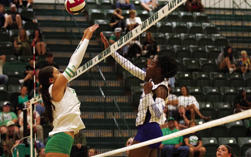 HUNTER KING | DISPATCH RECORD Angelina Davis challenges for a ball at the net against the Lady Bulldogs.