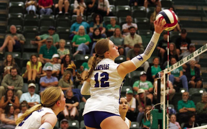 HUNTER KING | DISPATCH RECORD Kari Kepler swings for a kill during Tuesday’s contest.