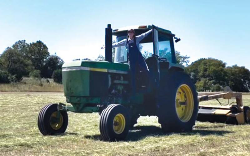 Jordan J. Herbst celebrates a job done in one of the hay fields she and her husband Jordan S. Herbst have farmed for the last several years. joycesarah mccabe | dispatch record