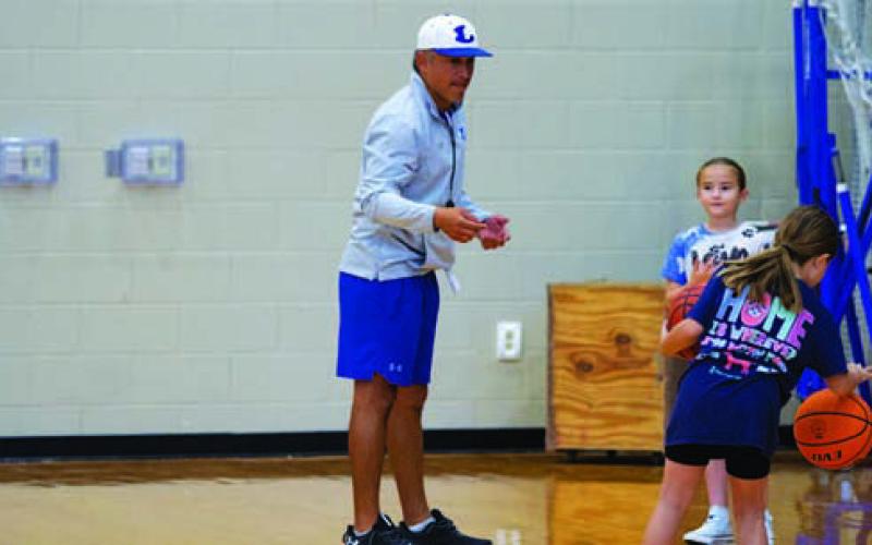 Marcus Chapa teaches shooting to young Lady Badgers. HUNTER KING | DISPATCH RECORD