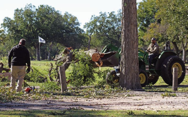 Hancock Park Golf Association members offered assistance Tuesday morning to clear debris from the golf course after high winds Monday night damaged trees and left the municipal course unplayable temporarily. JOYCESARAH MCCABE | DISPATCH RECORD