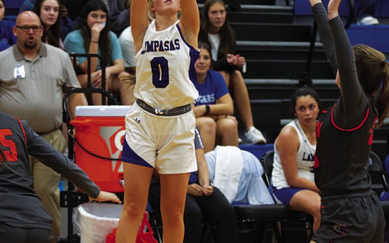 Addison Borchardt shoots a three-point shot over a defender. HUNTER KING | DISPATCH RECORD