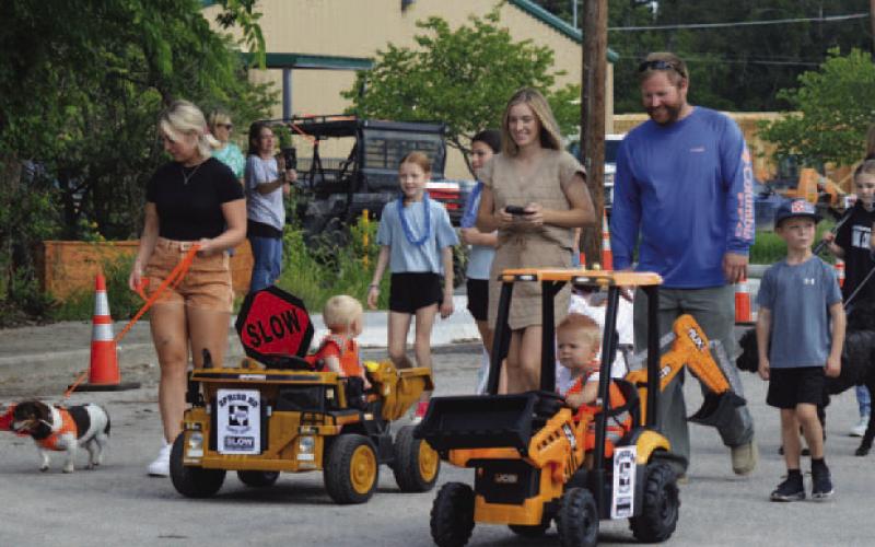 Spring Ho Pet Parade participants costumed as a Texas Department of Transporation Work crew enjoy the stroll down Live Oak Street. ERICK MITCHELL | DISPATCH RECORD