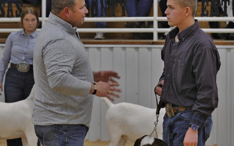 ERICK MITCHELL | DISPATCH RECORD At right, Mason Luna receives words of advice from show judge Preston Lawrence during Friday’s goat show.