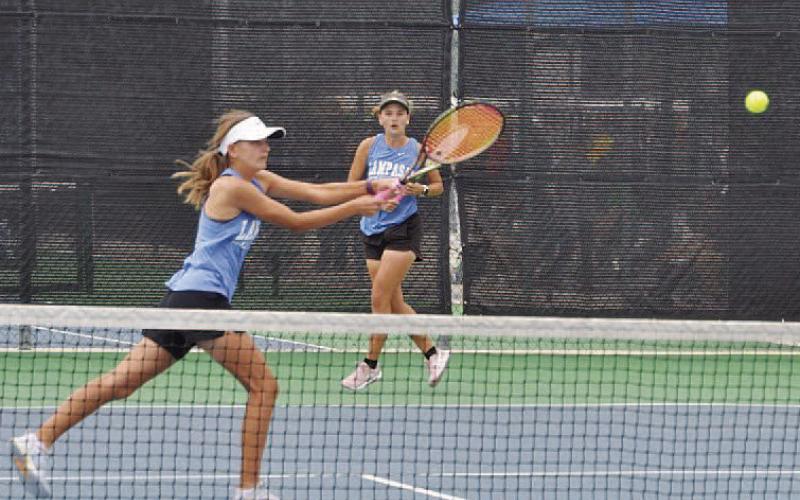 COURTESY PHOTO | KENNETH PEISER Madelynn White reaches for a shot as Caroline White watches her sister.