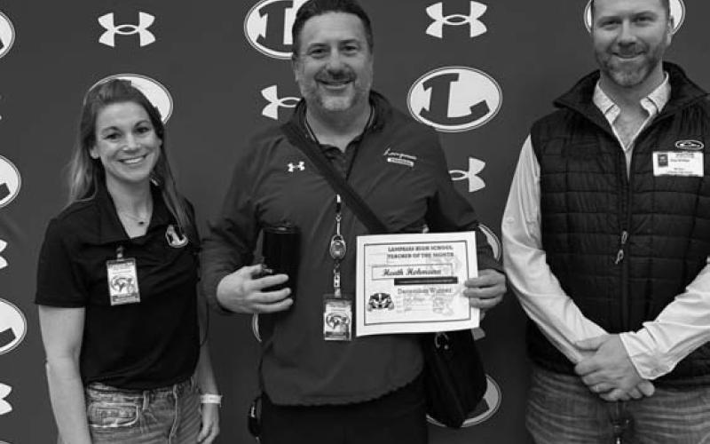 Assistant Principal Kristin Montague and Clay Phillips of Texas Farm Bureau Insurance were on hand to recognize Heath Hohmann as Teacher of the Month for December. COURTESY PHOTO