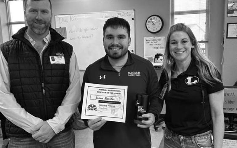 Clay Phillips of Texas Farm Bureau Insurance, at left, and Assistant Principal Kristin Montague congratulate Jaden Napolez on being named January Teacher of the Month. COURTESY PHOTO