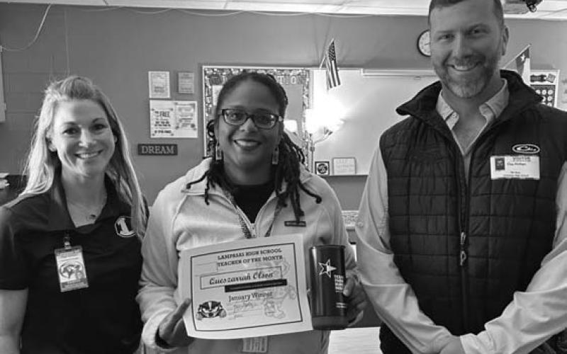 Assistant Principal Kristin Montague, left, and TFB Insurance representative Clay Phillips were on hand to honor Queszarrah Olson as January’s Teacher of the Month at Lampasas High School. COURTESY PHOTO