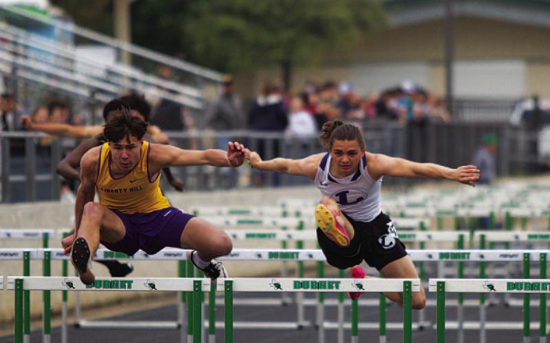 HUNTER KING | DISPATCH RECORD Asa White leaps over the final hurdle against his competition from Liberty Hill at last Thursday’s track meet in Burnet.