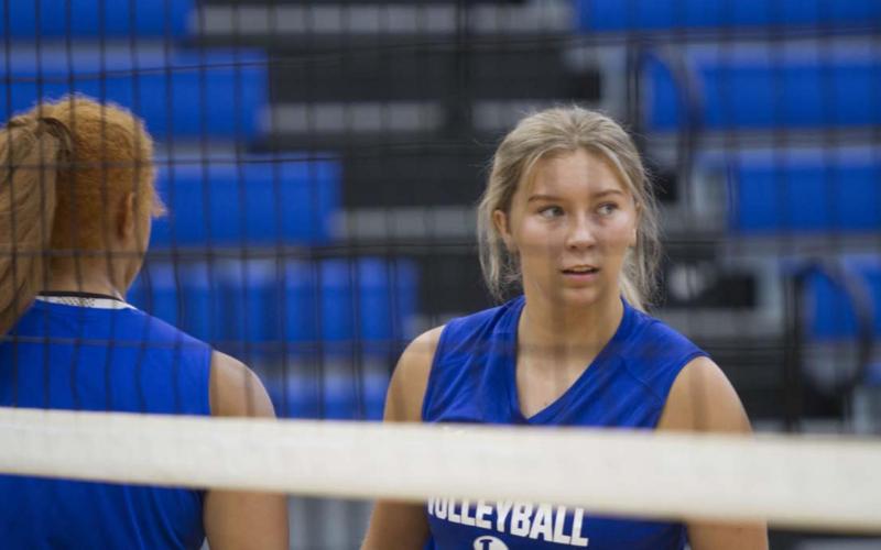 Madison Roedler looks over at head coach Christy Wiley between points during the volleyball scrimmage on Friday. HUNTER KING | DISPATCH RECORD