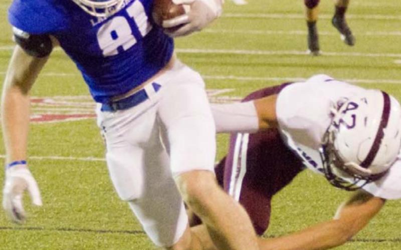 Receiver Carter Johnson stays in bounds on a reception as he is hit by a Uvalde Coyote. JEFF LOWE | DISPATCH RECOR