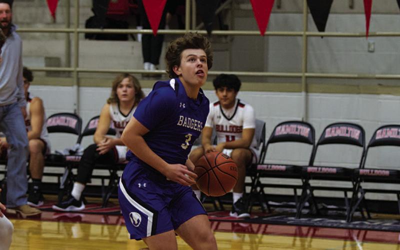 Aidan Nuckles dribbles to the basket for a layup against Hamilton. HUNTER KING | DISPATCH RECORD