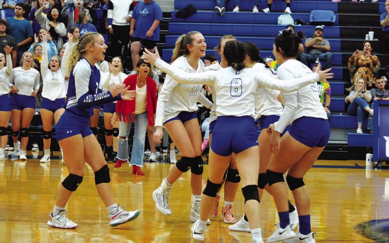 HUNTER KING | DISPATCH RECORD The Lady Badgers celebrate after a point in the third set against Gatesville on Tuesday.