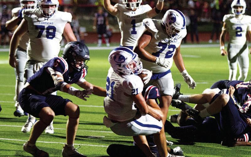 HUNTER KING | DISPATCH RECORD KJ Reed extends toward the goal line to score the late touchdown that gave the Badgers the lead against Wimberley.