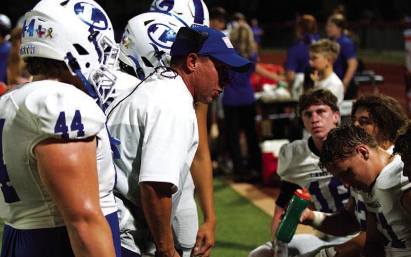 Defensive Coordinator Cory Warner talks with his group on the sideline. HUNTER KING | DISPATCH RECORD