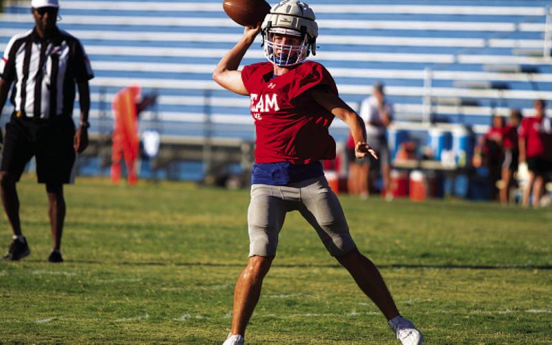 HUNTER KING | DISPATCH RECORD JT Posten rolls to his right and throws into the flat during last Friday’s scrimmage.
