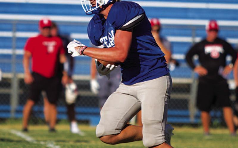 Preston Isom breaks up the middle of the field for his touchdown during the scrimmage. HUNTER KING | DISPATCH RECORD