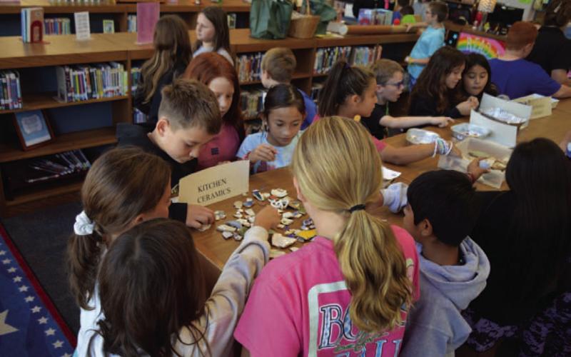 Hanna Springs Elementary School fourth-grade students get a close look at kitchen ceramic pieces that were used by Native Americans in Texas. ERICK MITCHELL | DISPATCH RECORD