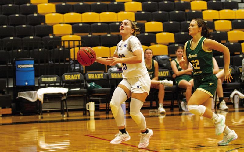Payton Crawford drives to the basket during the game against Harper on Saturday morning. HUNTER KING | DISPATCH RECORD