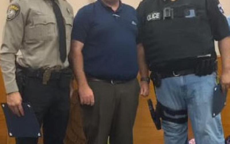 Kempner Mayor John Wilkerson, center, honors Lampasas County Sheriff’s Office Deputy Raymond Barrera, left, and Interim Chief of Police Heriberto “Eddie” Rodriguez during the Kempner City Council’s meeting July 27. CITY OF KEMPNER FACEBOOK