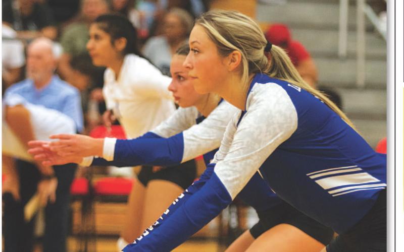 Brailey Wilson, Landry White and Arielle Aguire await a serve. HUNTER KING | DISPATCH RECORD