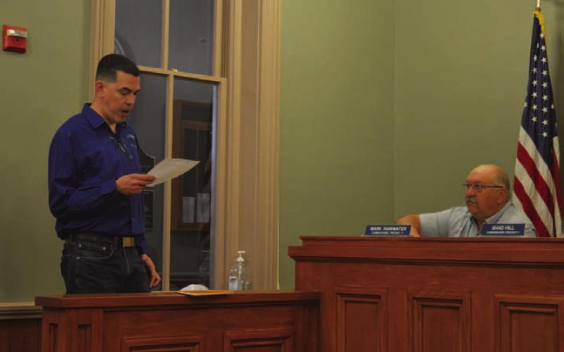 Derrick Berrios, director of the Lampasas County Higher Education Center, speaks to the Lampasas County Commissioners Court to provide an update on course offerings and vocational programs available. Pictured at right is Precinct 4 Commissioner Mark Rainwater. ERICK MITCHELL | DISPATCH RECORD