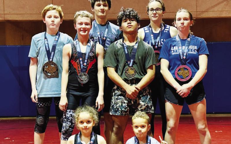 These young wrestlers pose with their medals from the recent tournament. HUNTER KING | DISPATCH RECORD