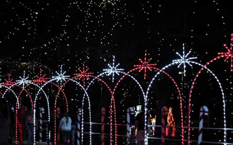 JOYCESARAH MCCABE | DISPATCH RECORD The Candy Cane Lane glitters brilliantly along the creekfront at W.M. Brook Park every year during the Christmas season.