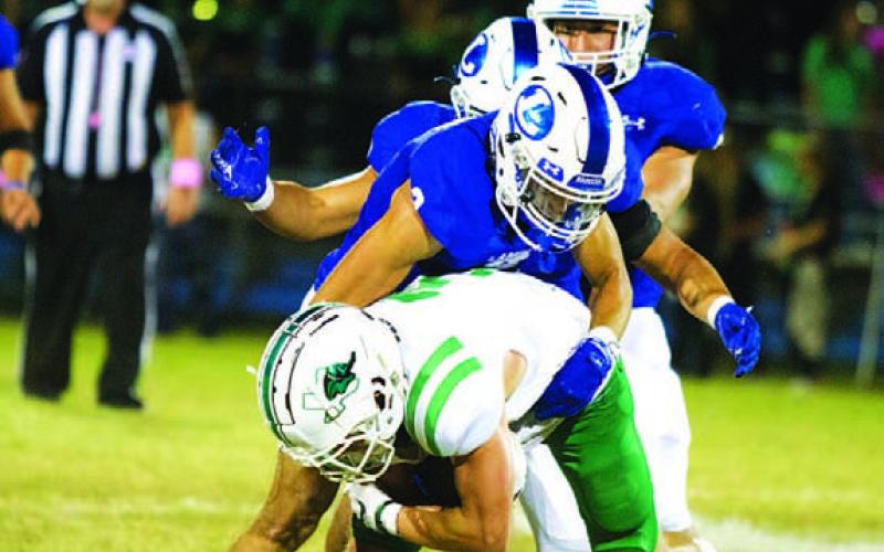 Ayden Shaw wrangles the Burnet receiver to the ground. HUNTER KING | DISPATCH RECORD