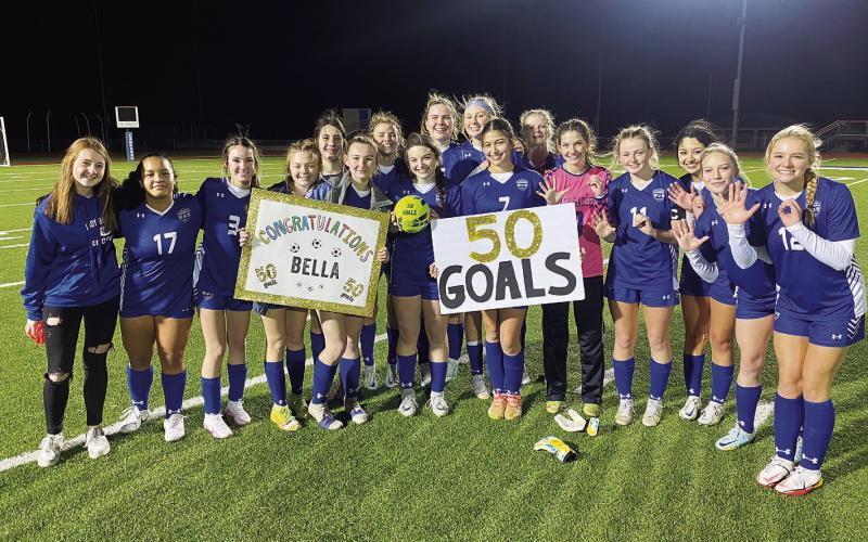 The Lady Badger soccer team celebrates with Bella Lindsey after their win and her 50th and 51st career goals. COURTESY PHOTO