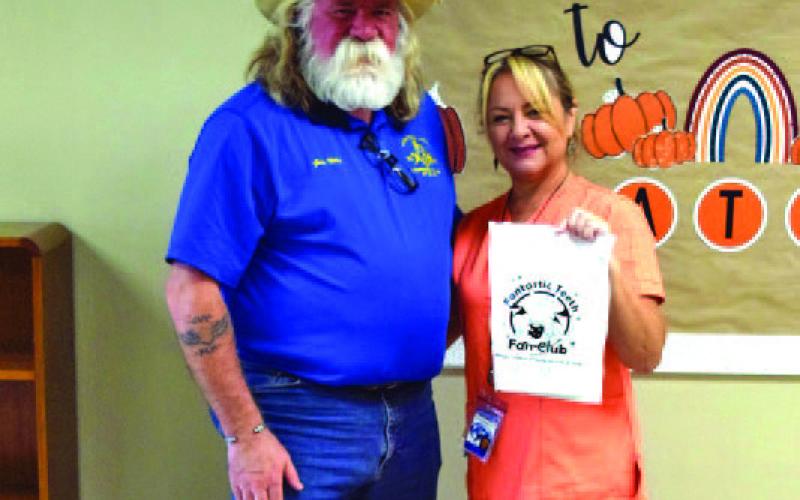 Lodge Master Guy Niles is pictured with Kline Whitis Elementary School nurse Dana Tatum, who displays one of the “Fantastic Teeth” dental kits Saratoga Lodge provided to the campus. COURTESY PHOTO